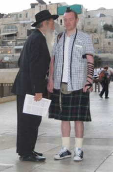 guy with kilt at kotel wearing tephilin
